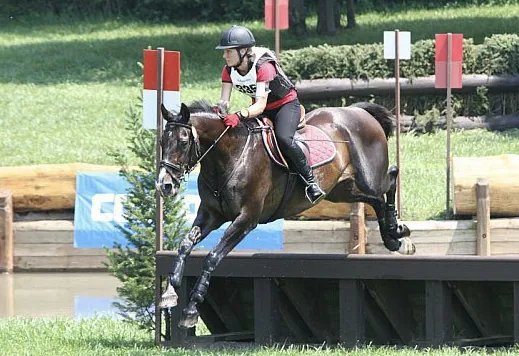 Jean Storie jumping a cross-country fence while eventing