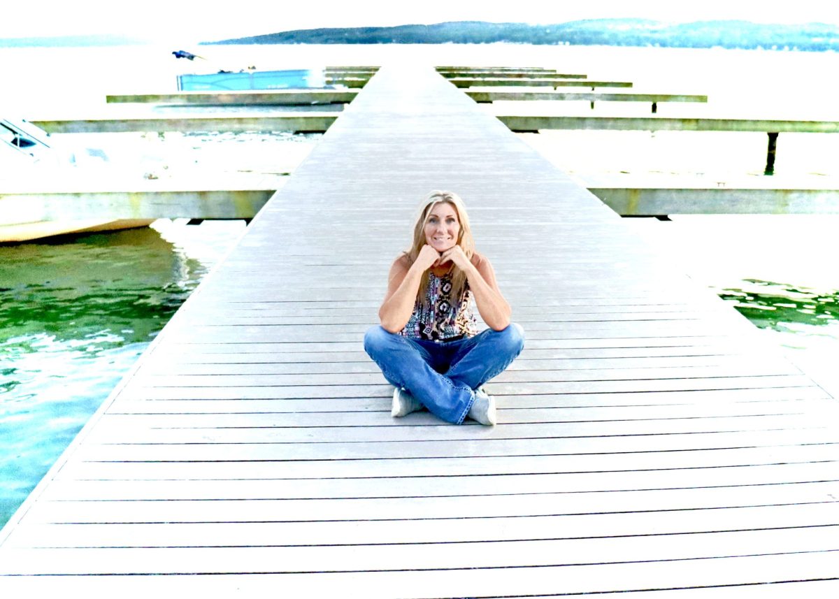 Jean Storie sitting on a dock in the Finger Lakes